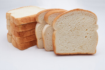 Eight (8) slices of freshly baked Jamaican hard dough bread isolated on a white background