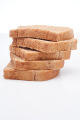 Five (5) slices of freshly baked Jamaican whole wheat bread isolated on a white background