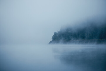 Misty Morning Atmosphere Over a Calm Lake