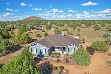 A charming blue house featuring white shutters adorning the windows