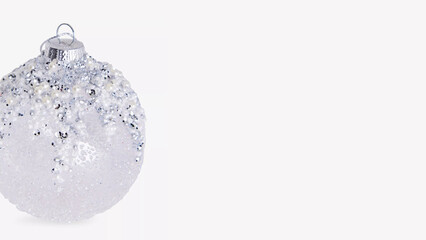 Decorative silver holiday ornament featuring intricate design and sparkling accents for festive celebrations.