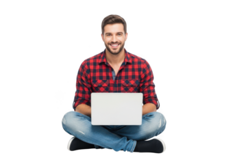 Smiling young man in a red plaid shirt and jeans sits cross legged on a black background holding a white laptop with a blank screen