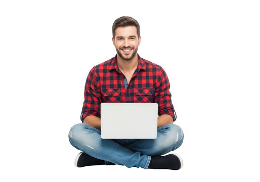 Smiling young man in a red plaid shirt and jeans sits cross legged on a black background holding a white laptop with a blank screen