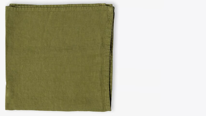 Soft green linen napkin neatly folded on a simple background for elegant dining decoration.