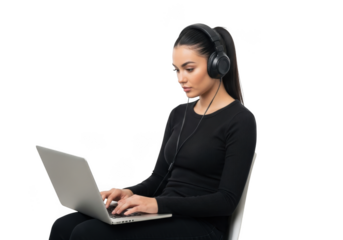 Focused young woman wearing headphones works diligently on a laptop computer against a stark black background demonstrating concentration and modern technology use