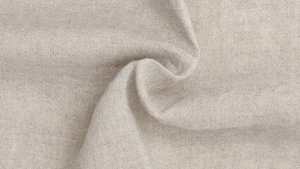 Soft beige fabric draping elegantly, perfect for interior design and fashion projects, showcasing its natural texture and versatility.