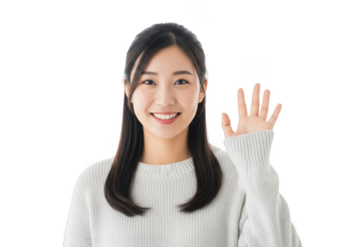 A young asian woman with long dark hair smiles warmly raising her hand in a friendly greeting against a stark black background - Powered by Adobe