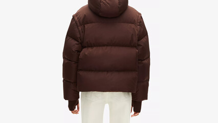 Stylish brown puffer jacket paired with light-colored jeans during a casual outing in fall weather.