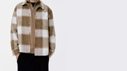 Stylish men's outerwear features a brown and white plaid design, perfect for fall fashion.