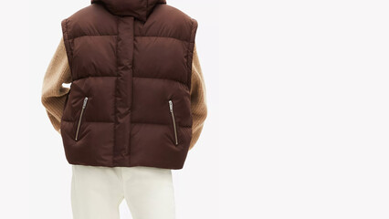 Stylish outfit featuring a brown puffer vest and a cozy sweater, perfect for cool weather gatherings.