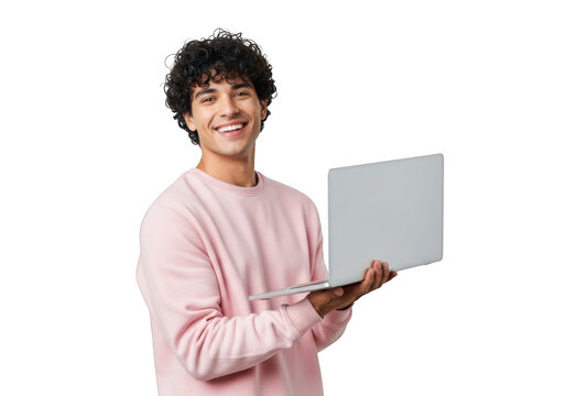 Young man with curly dark hair wearing a pink sweatshirt smiles while holding a silver laptop computer against a black background