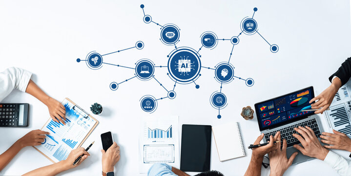 A diverse team engages in a collaborative session focused on artificial intelligence strategy, utilizing data analytics tools and visual presentations in a modern workspace. Amity