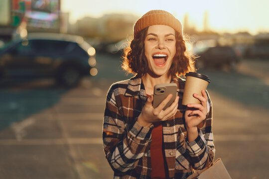 woman coffee smartphone smile candid golden urban lifestyle authenticity and golden hour glow capture mindful living and emotional storytelling in a spontaneous, joyful urban portrait of real joy - Powered by Adobe