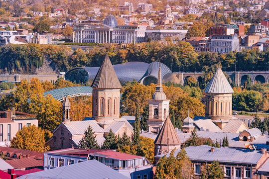 Tbilisi cityscape with autumn trees, showcasing historical church