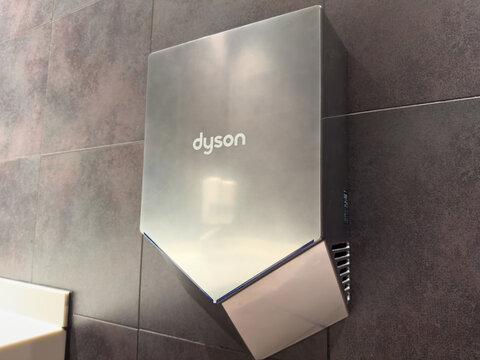 Villach, Austria - November 18, 2025: Dyson hand dryer mounted on a modern bathroom wall, showcasing sleek design and efficient technology for quick hand drying in public restrooms