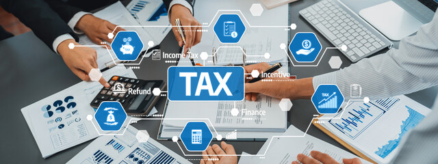 A dynamic tax planning session showcasing hands collaborating over financial documents and...