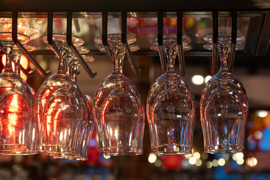 Wine glasses hanging up in a bar
