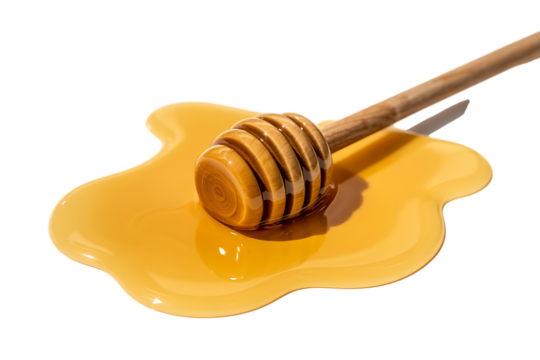 A wooden honey dipper rests in a pool of golden honey on a white background.