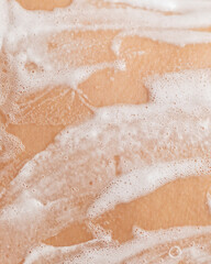 Macro photo of soapy foam texture on wet skin