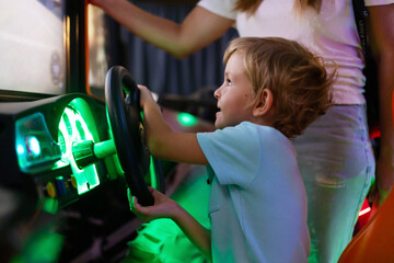 Child Enjoying Arcade Racing Game with Steering Wheel