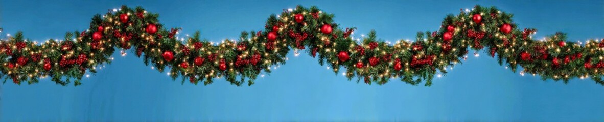 Festive Christmas Garland With Red Ornaments On Blue Background