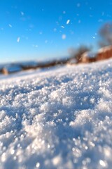 A close-up view of glittering snow crystals in bright sunlight with falling flakes and a soft blurred background