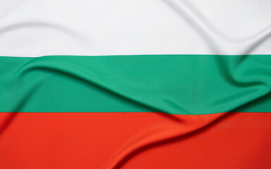 Obraz premium A photograph of the Bulgarian flag serving as a clean, vibrant background with its three horizontal stripes clearly defined. The top stripe displays a rich white color, the middle stripe shows a vivid