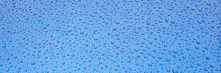 Clear blue surface with water drops close up for texture, background, and design use