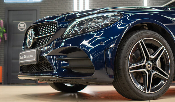 Blue Mercedes-Benz C-Class AMG 43 C 200 IV (W205) coupe in the showroom after detailing. Exterior of a blue Mercedes-Benz C-Class AMG 43. Car tuning, styling. Germany sport car.