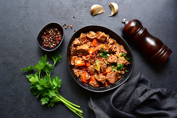 Goulash (meat stew with tomatoes and paprika) - traditional dish of hungarian cuisine .Top view with copy space.