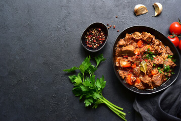 Goulash (meat stew with tomatoes and paprika) - traditional dish of hungarian cuisine .Top view with copy space.