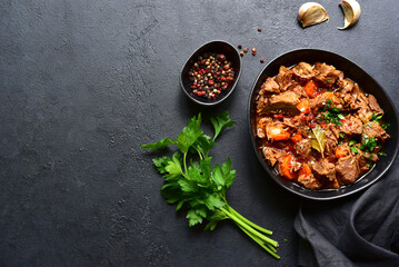 Goulash (meat stew with tomatoes and paprika) - traditional dish of hungarian cuisine .Top view with copy space.