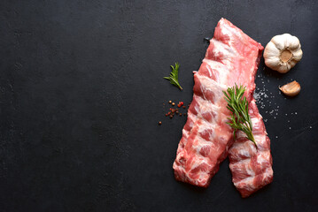 Raw pork ribs with ingredients for cooking. Top view with copy space.