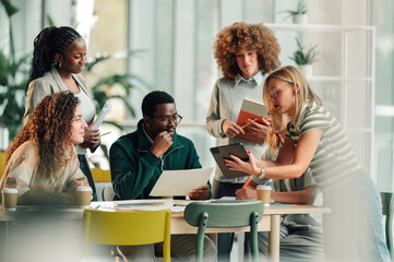 Diverse business team collaborating in modern office meeting