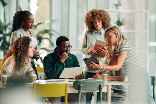 Diverse business team collaborating in modern office meeting - Powered by Adobe