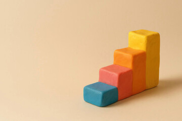 Obraz premium Colored plasticine growth blocks on a beige background. Space for text.