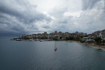 Fototapeta premium Aerial view of Sarande, a historic Albanian harbor town on the Ionian coast, featuring waterfront landmarks, boats, and Mediterranean architecture.Saranda city