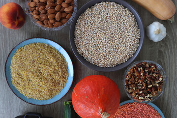 Assortment of various healthy fruits, vegetables, grains and legumes. Top view, wooden background.