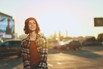 Woman smile candid golden urban beanie plaid lifestyle portrait of a young woman laughing at...
