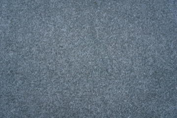 dark speckled gray surface background texture with fine granular pattern concept of acoustic paneling, textile design, stone products