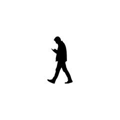 Modern silhouette of man walking while using his smartphone, a connected lifestyle and modern technology