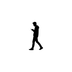 Modern silhouette of young man using phone while walking, communicating and navigating urban life