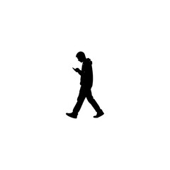 Silhouette of person walking while looking at phone offers striking modern design element for your project