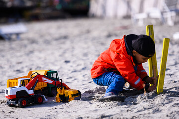Child playing construction game with toys on beach © Zoran Jesic