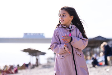 Fototapeta premium Happy young girl enjoying sunny day at beach