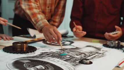 A vibrant workshop showcasing hands engaged in the design of mechanical components. Participants collaborate on technical drawings, emphasizing teamwork and innovation in engineering. SACTR - Powered by Adobe