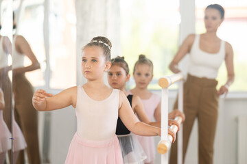 Lesson for little ballerinas - girls learn to dance ballet in a choreographic class © JackF