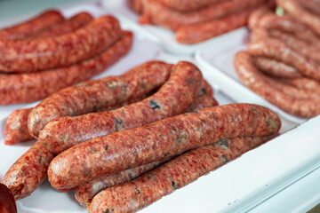 Sausages bufifarra made of pork and chicken minced meat ready for grilling in meat shop