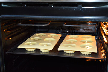 pouring liquid muffin batter into silicone baking mold. making dessert at home. tasty food for kids and adults