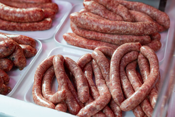 Sausages bufifarra made of pork and chicken minced meat ready for grilling in meat shop